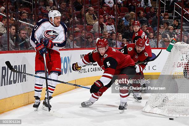 David Clarkson of the Columbus Blue Jackets centers the puck past Connor Murphy of the Arizona Coyotes during the NHL game at Gila River Arena on...