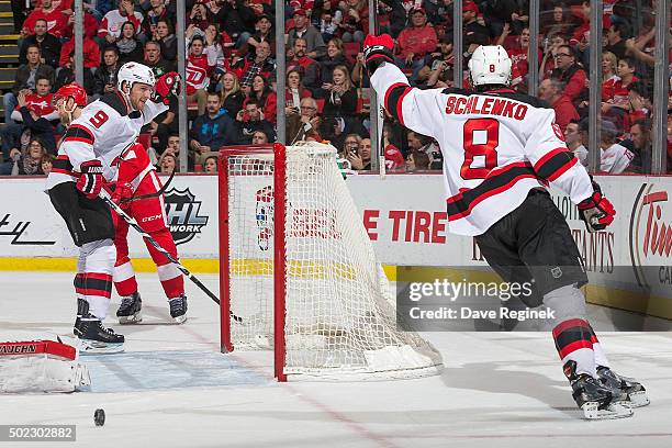 David Schlemko of the New Jersey Devils celebrates his first period goal with teammate Jiri Tlusty during an NHL game against the Detroit Red Wings...