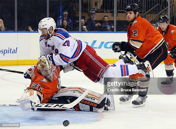 Kevin Bieksa of the Anaheim Ducks is called for crosschecking Dominic Moore of the New York Rangers into John Gibson during the second period at...