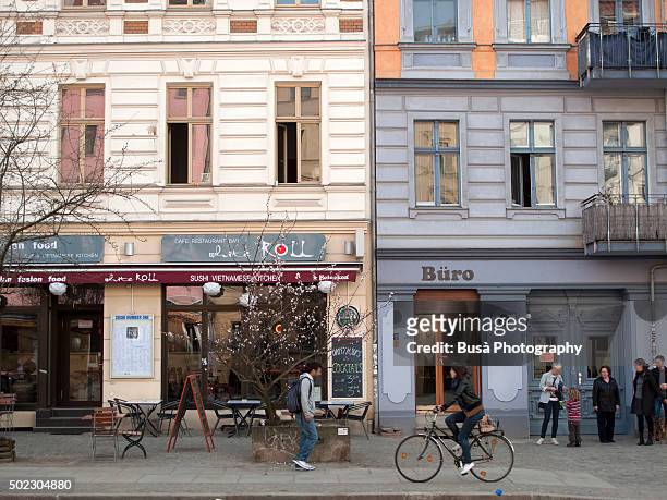 street scene in oderbergerstrasse, in berlin, district of prenzlauerberg, germany - berlin cafe stock pictures, royalty-free photos & images