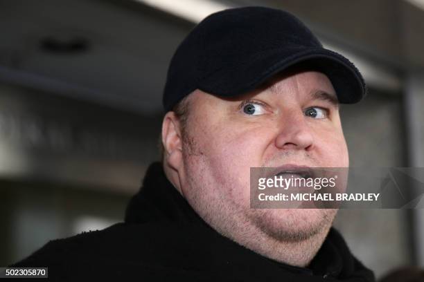 Internet mogul Kim Dotcom leaves court after a judge ruled that he and three other defendants are eligible for extradition to the US, in Auckland on...