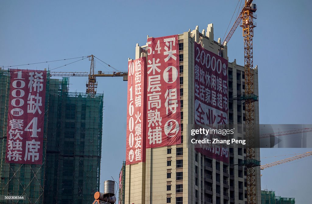 Huge promotion advertisement hangs on a real estate project...
