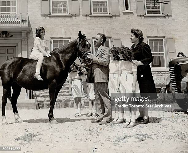 Tenth birthday gift for the Dionne quintuplets was this pony presented to them by their father. The quints; celebrating their anniversary in their...