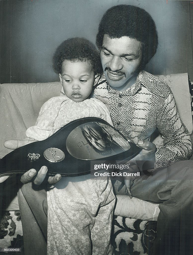 Title Belt: Clyde Gray shows his 2-year-old daughter; Jennifer; the championship belt presented to h