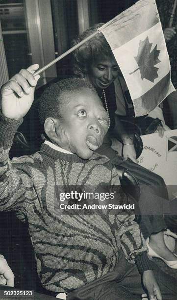 Hopeton Edwards: Jamaican boy; born with neurofibromatosis; waves Canadian flag upon arrival in Metro last night.