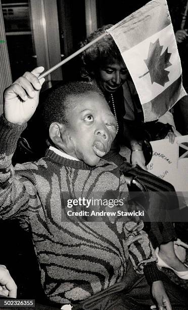Hopeton Edwards: Jamaican boy; born with neurofibromatosis; waves Canadian flag upon arrival in Metro last night.