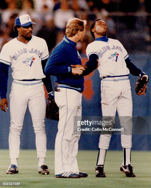 Tony's year is over: Blue Jays shortstop Tony Fernandez; attended by trainer Tommy Craig grimaces with pain after being upended by Bill Madlock of...