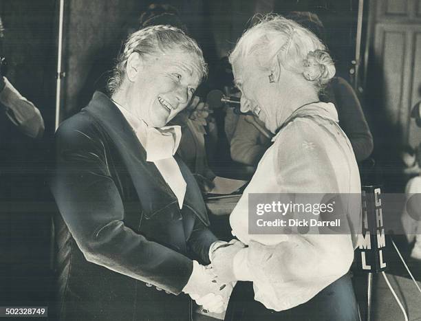 The first woman cabinet-minister in Canada's history; Ellen Fairclough ; laughs with Lieutenant-Governor Pauline McGibbon after being named one of...