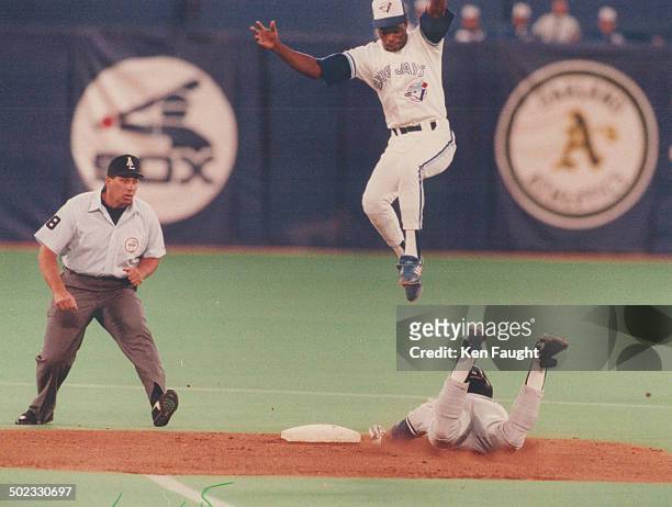 Yikes! Blue Jays shortstop Tony Fernandez made sure he was out of th eway when an untrussed chicken suddenly appeared . . . Er . . . Make that when...