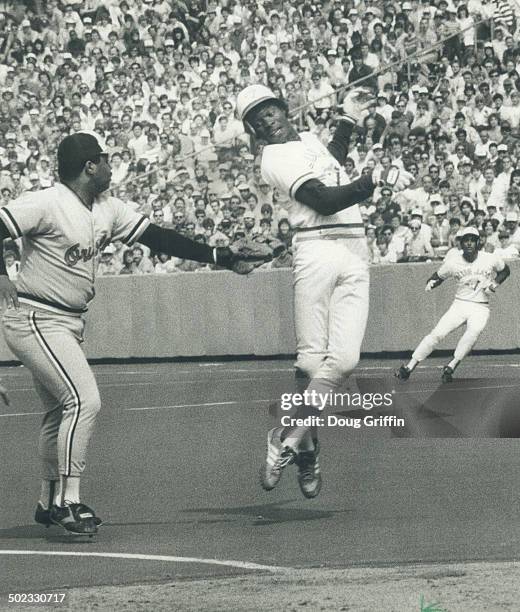 New dance step: Blue Jays' shortstop Tony Fernandez appears to be performing a dance as he tries to avoid tag by third baseman Floyd Rayford of...