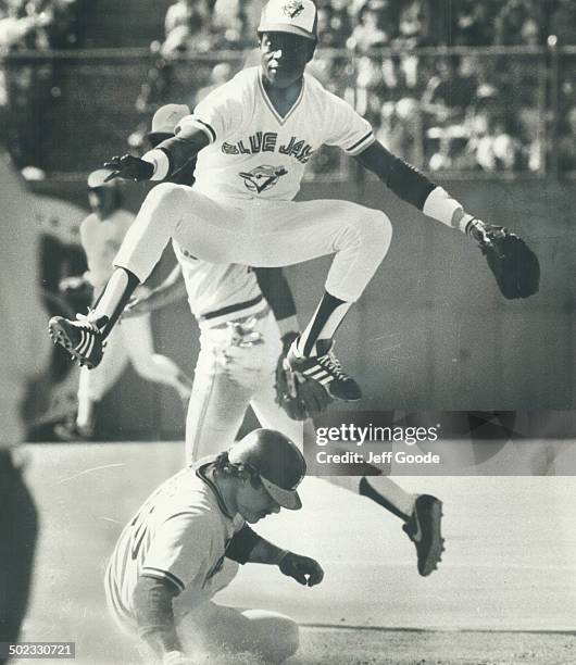 His skills honed in his native Dominican Republic; Toronto Blue Jay shortstop Tony Fernandez leaps high to get off a throw to first base. He hails...