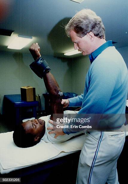 The unofficial Minister of Arms in the Blue Jays clubhouse is head trainer Tommy Criag; here helping Tony Fernandez strengthen his elbow.