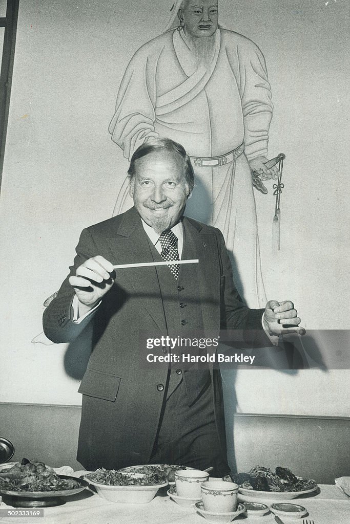 Bandleader Skitch Henderson finds his choptick an ideal instrument for putting on an impromptu condu