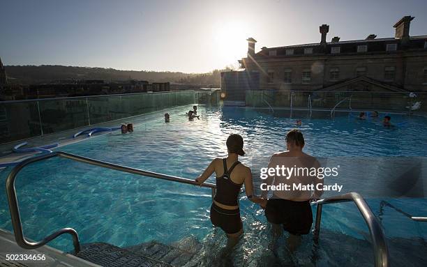 Bathers enjoy naturally warmed spa water as they relax in the rooftop pool of the Thermae Bath Spa, Britain's only natural thermal spa on December...