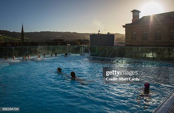 Bathers enjoy naturally warmed spa water as they relax in the rooftop pool of the Thermae Bath Spa, Britain's only natural thermal spa on December...