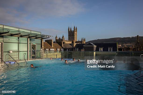 Bathers enjoy naturally warmed spa water as they relax in the rooftop pool of the Thermae Bath Spa, Britain's only natural thermal spa on December...