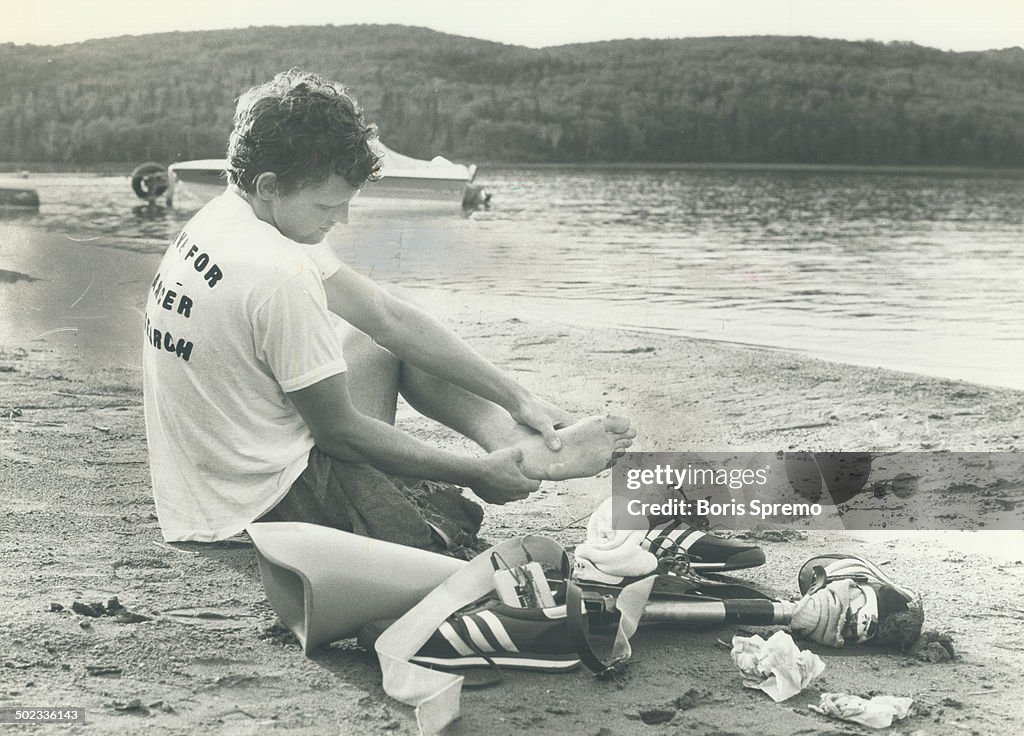 Moment's rest: Terry Fox takes a break near Marathon; Ont.; during long hard week of running.
