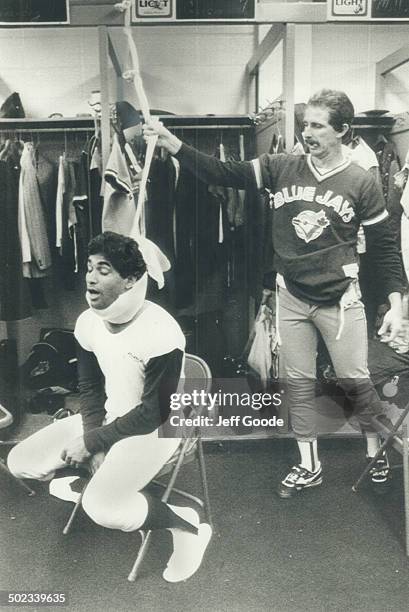 Garcia was only kidding: Damasco Garcia pretends to be hanging himself in the Blue Jays' dressingroom - with a helping hand from Rance Mulliniks - in...