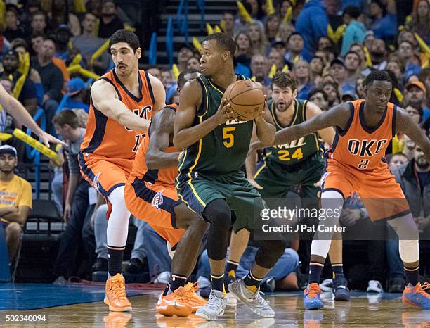 As Oklahoma City Thunder players apply pressure Rodney Hood of the Utah Jazz looks for a play during a NBA game at the Chesapeake Energy Arena on...