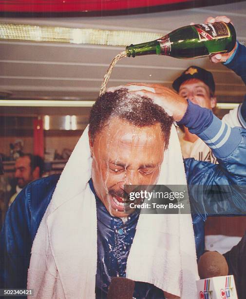 He's all wet: The bubbly and beer was flying in the clubhouse as manager Cito Gaston gets a thorough drenching.