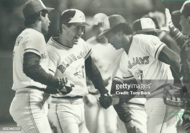The glad hands: Jays' Garth lorg was the happy centre of attention of teammates Damaso Garcia; left; and George Bell after his two-run single lifted...