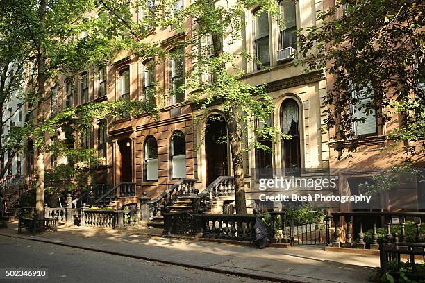brownstones in a quiet residential street in manhattan, new york city - chelsea new york fotografías e imágenes de stock