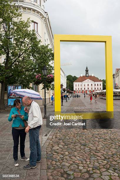 yellow national georgraphic frame and town hall in tartu, estoni - national geographic stock pictures, royalty-free photos & images