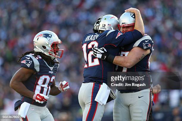 Tom Brady of the New England Patriots celebrates with Josh Kline after throwing a touchdown pass to James White during the second quarter against the...