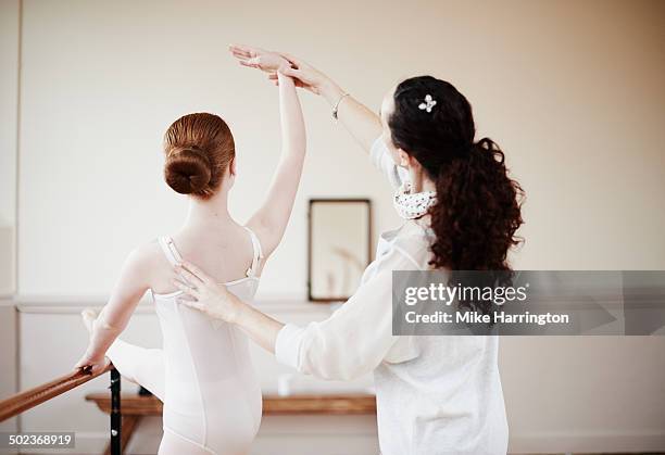 ballet dancer taking instruction from her teacher. - barre navigation stock pictures, royalty-free photos & images