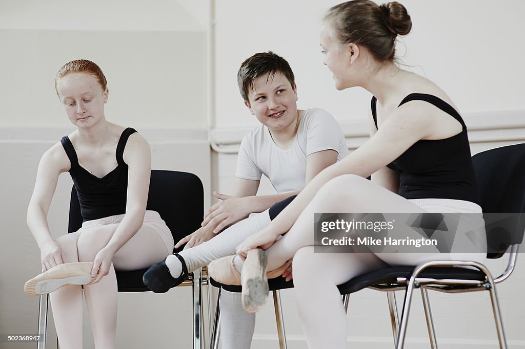 Young ballet dancers talking at practise.