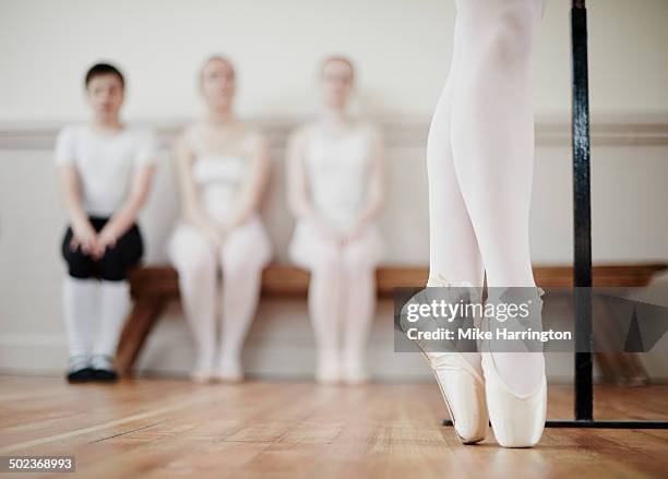 close up of ballet dancer performing point work - tween heels stock pictures, royalty-free photos & images