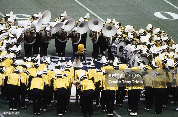 Super Bowl XII: View of marching band in huddle at 50 yard line during pregame festivities before Dallas Cowboys vs Denver Broncos game at Louisiana...