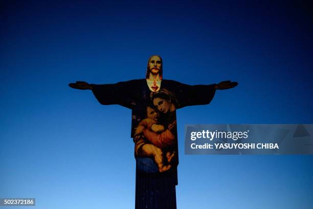 View of the statue of Christ the Redeemer illuminated by Brazil-based French lighting designer Gaspare Di Caro at the Corcovado hill in Rio de...