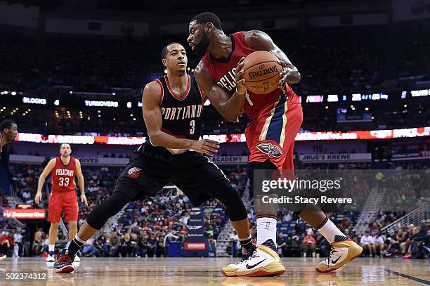 Tyreke Evans of the New Orleans Pelicans works against C.J. McCollum of the Portland Trail Blazers during the first half of a game at the Smoothie...