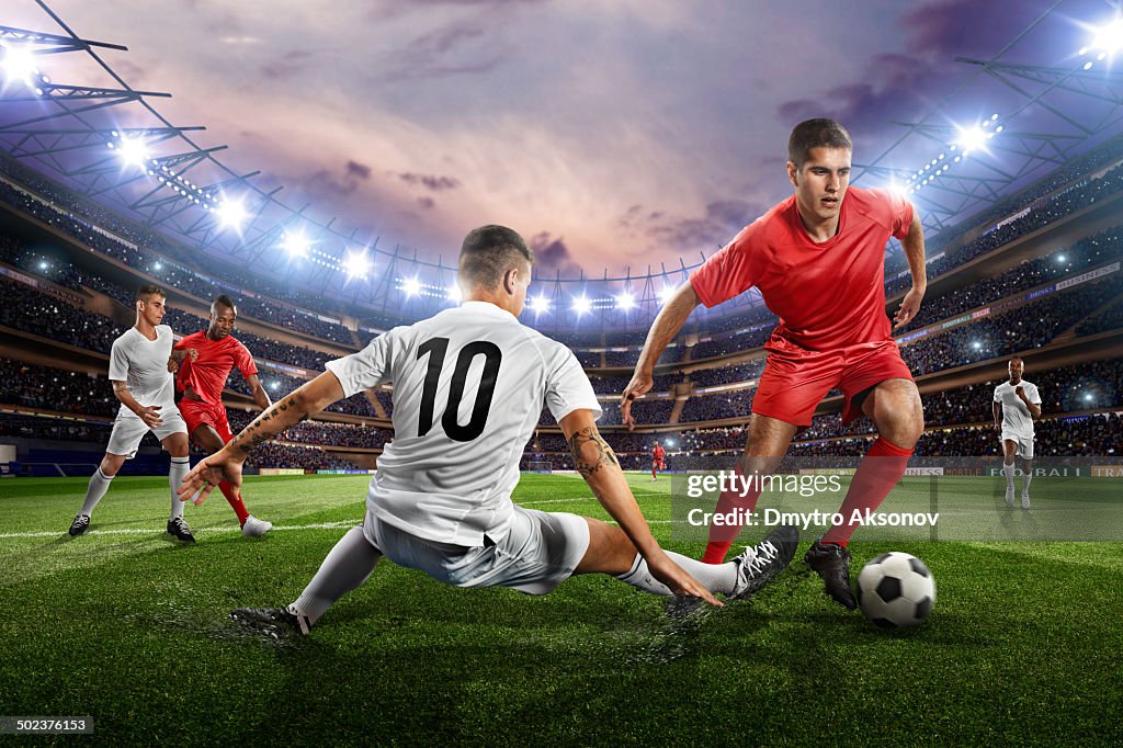 Soccer players in action on soccer stadium