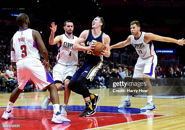 Gordon Hayward of the Utah Jazz drives on Chris Paul, J.J. Redick and Blake Griffin of the Los Angeles Clippers at Staples Center on November 25,...