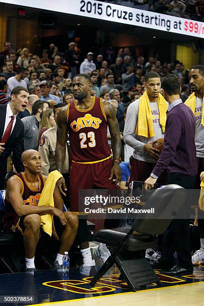 LeBron James of the Cleveland Cavaliers reacts after walking courtside during a timeout to check on Ellie Day, wife of professional golfer Jason Day,...