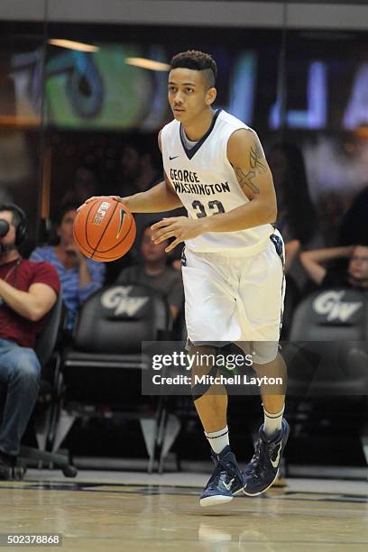 Joe McDonald of the George Washington Colonials dribbles up court during a college basketball game against the Rutgers Scarlet Knights at the Smith...