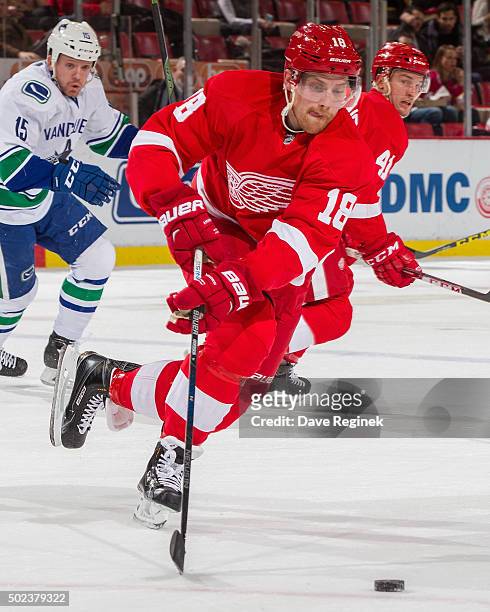 Joakim Andersson of the Detroit Red Wings turns up ice with the puck during an NHL game against the Vancouver Canucks at Joe Louis Arena on December...