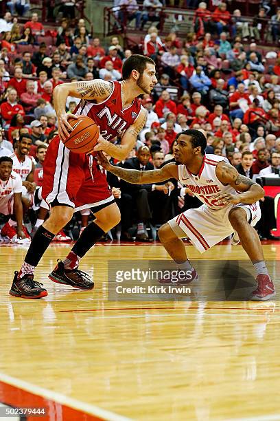 Harris of the Ohio State Buckeyes defends against Michael Orris of the Northern Illinois Huskies during the game at Value City Arena on December 16,...
