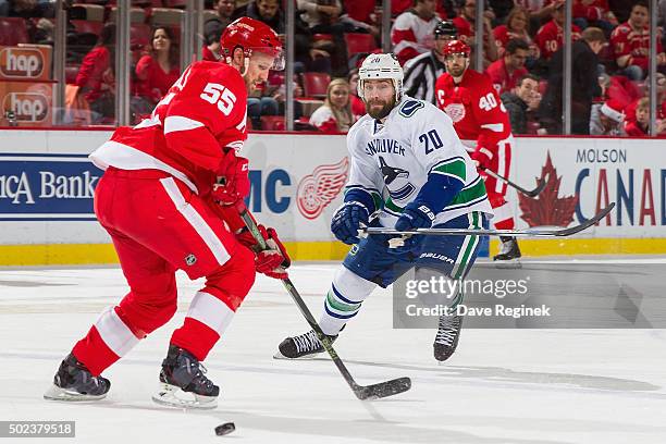 Niklas Kronwall of the Detroit Red Wings looks for the puck as he gets pressure form Chris Higgins of the Vancouver Canucks during an NHL game at Joe...