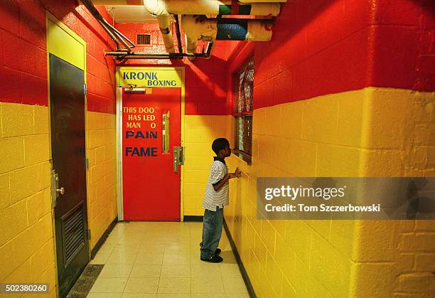 Boy in the hallway of the basement of the Kronk boxing gym inside the recreation center building on January 17, 2006 in Detroit, Michigan.