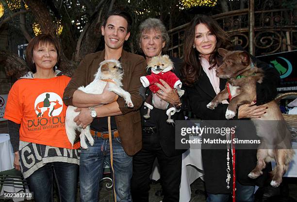 Activist Andrea Gung, Vanderpump Pets COO John Sessa, Ken Todd and TV personality Lisa Vanderpump pose with dogs that were rescued from the Yulin dog...