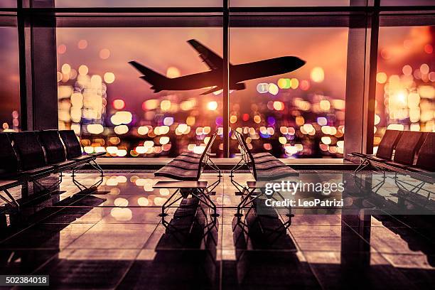 airport lounge and airplane take off in the city - airport departure area stockfoto's en -beelden