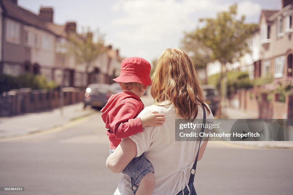 Mother and son looking down suburban road