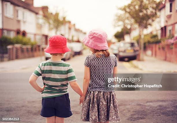 young friends off for a suburban walk - boy skirt stock pictures, royalty-free photos & images