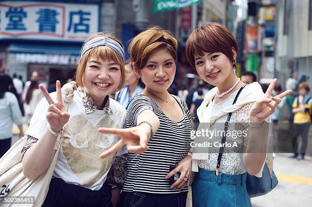 three japanese young women - street fashion japan stock-fotos und bilder