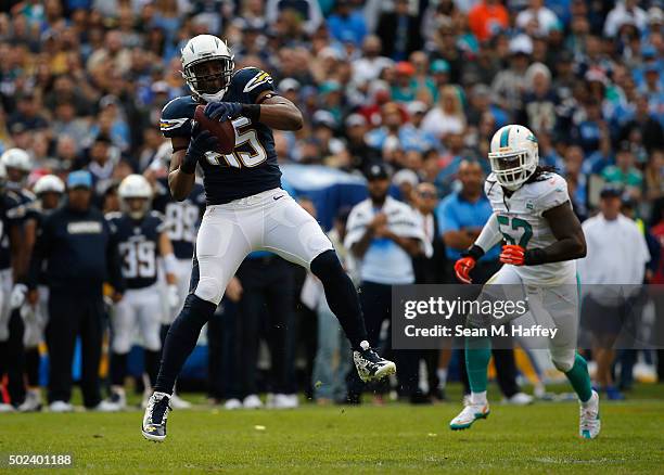 Antonio Gates of the San Diego Chargers catches a pass as Kelvin Sheppard of the Miami Dolphins defends during a game at Qualcomm Stadium on December...