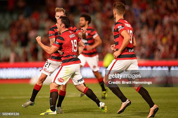 Mark Bridge of the Wanderers celebrates scoring a goal with team mates during the round 12 A-League match between the Western Sydney Wanderers and...
