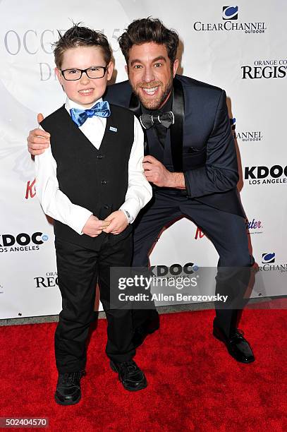 Singer Elliott Yamin and Cade Spinello attend the OC Christmas Extravaganza Concert and Ball at Christ Cathedral on December 23, 2015 in Garden...